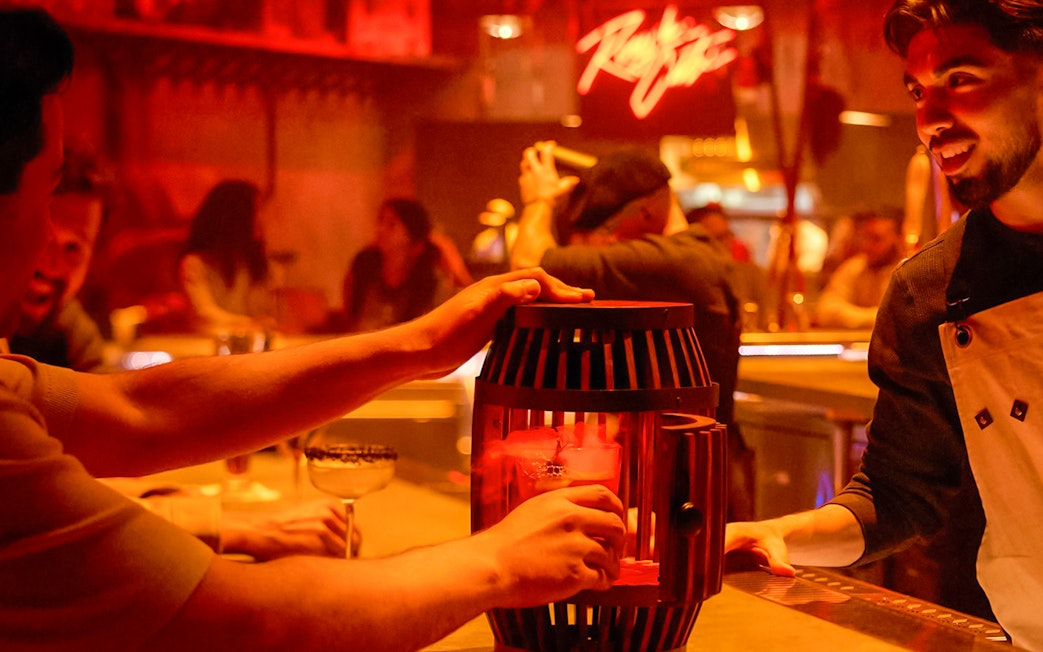 Bartender serving themed drinks at Las Vegas Universal Horror Unleashed event.