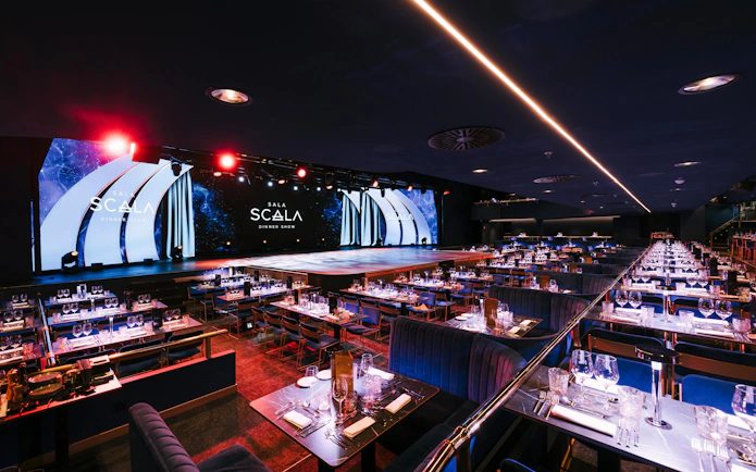 Seating area at Sala Scala Gran Canaria with tables set for a dinner show.