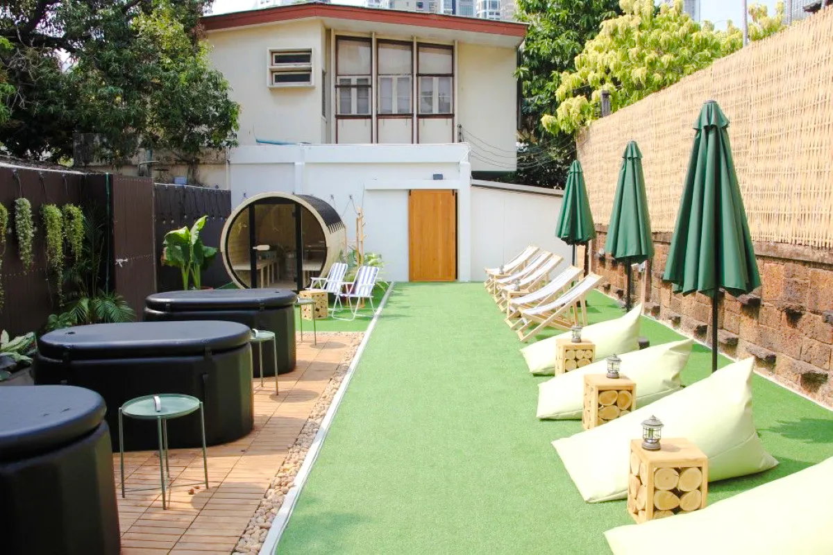 Outdoor ice bath and sauna area with lounge chairs in Secret Garden, Bangkok.