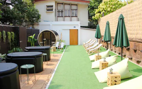 Outdoor ice bath and sauna area with lounge chairs in Secret Garden, Bangkok.
