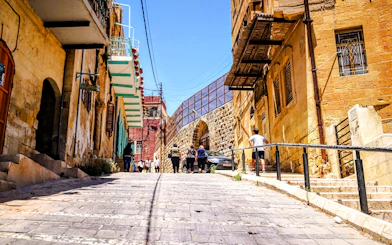 Historic street in As-Salt with tourists walking, part of the Half-Day Harmony Trail from Amman.