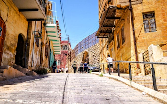 Historic street in As-Salt with tourists walking, part of the Half-Day Harmony Trail from Amman.