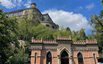 Chapultepec Castle on a hill surrounded by trees in Mexico City.