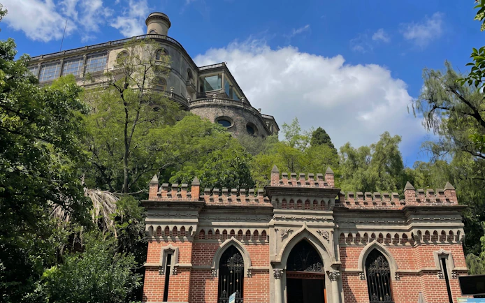 Chapultepec Castle on a hill surrounded by trees in Mexico City.