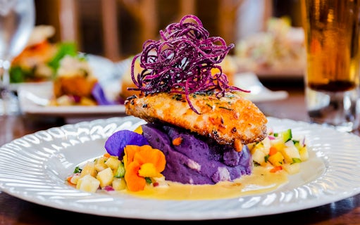 Grilled fish on purple mashed potatoes with pineapple salsa, part of Pineapple Farm Tour & Gourmet Dining Experience.