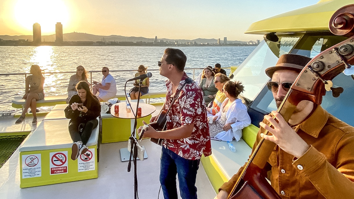 Tourists enjoying a Catamaran Cruise in Barcelona with a view of the city skyline