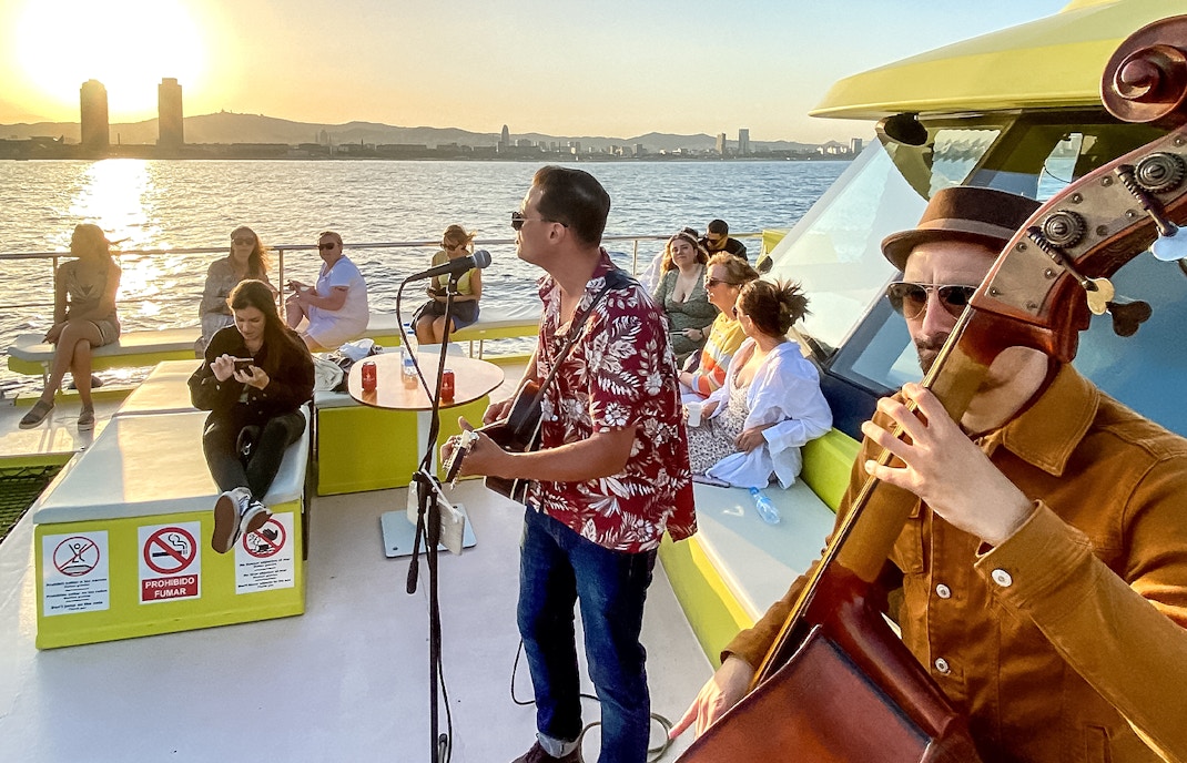 tourist enjoying a live music show on the Eco-Catamaran cruise