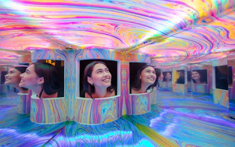 Guests exploring colorful mirrored exhibits at the Twist Museum in London.