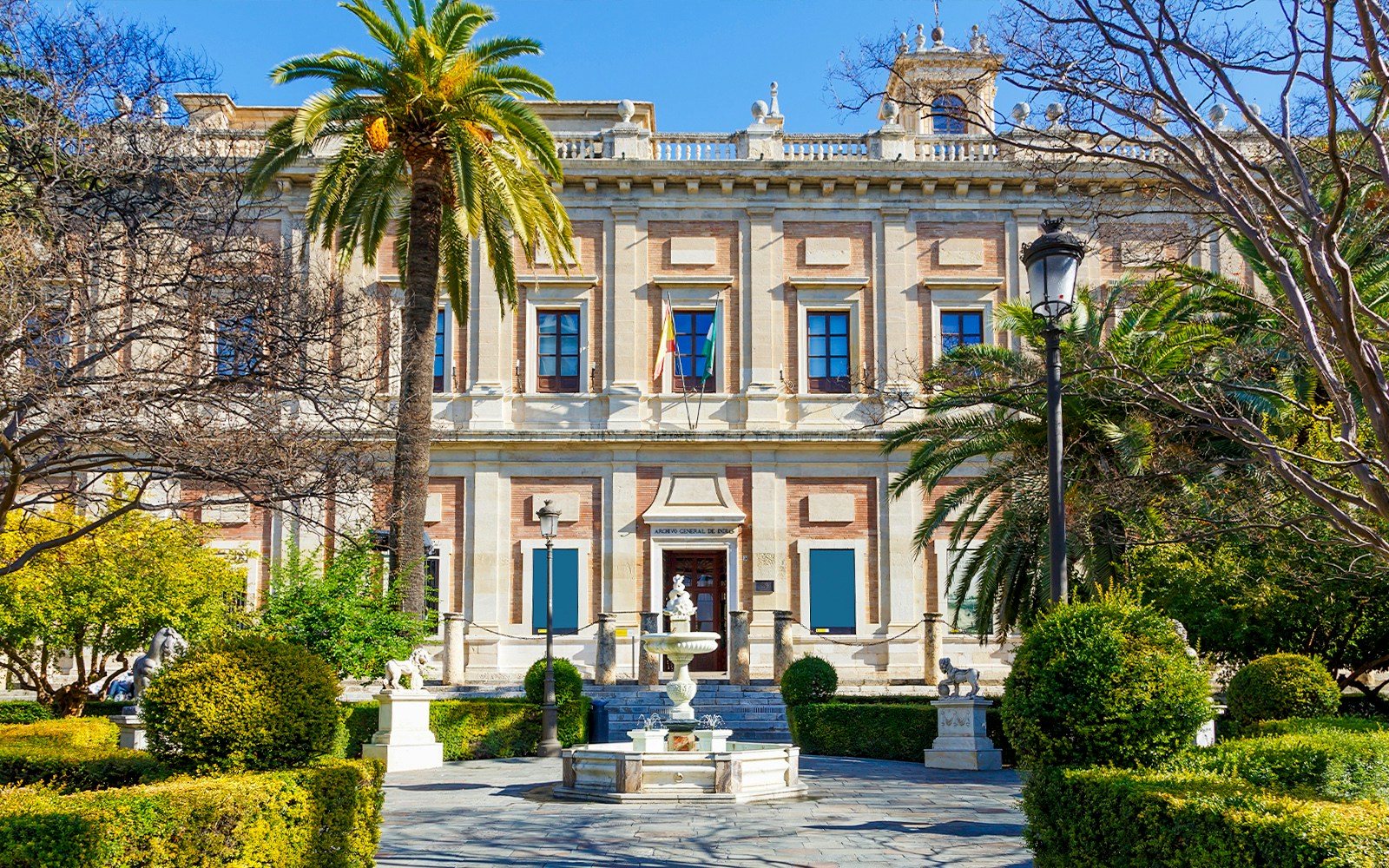 Archivo de Indias building with garden and fountain in Seville, Spain.