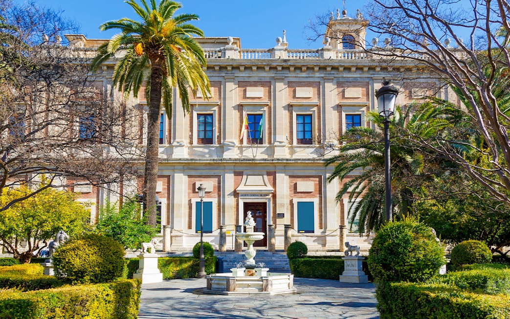 Archivo de Indias building with garden and fountain in Seville, Spain.