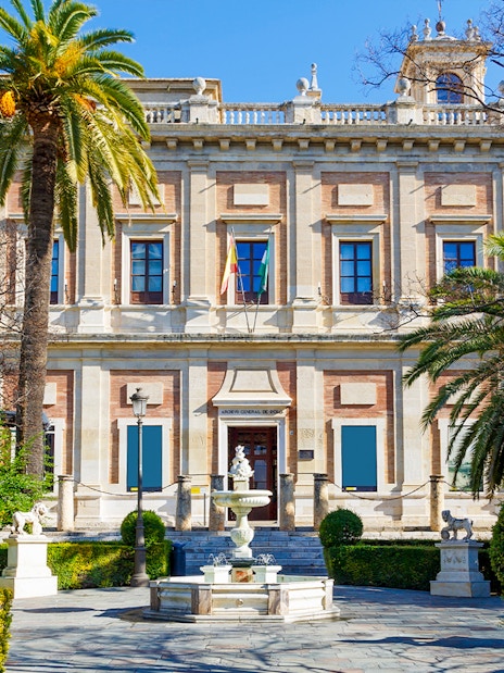 Archivo de Indias building with garden and fountain in Seville, Spain.