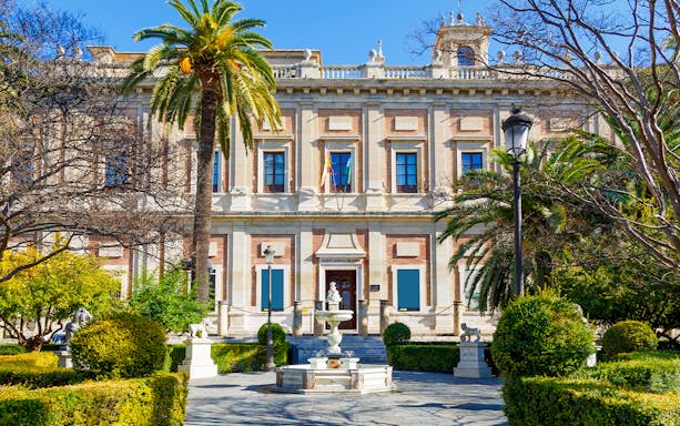 Archivo de Indias building with garden and fountain in Seville, Spain.