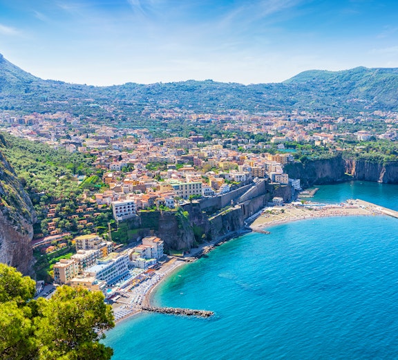 Aerial view of Sorrento coastline with cliffs and blue sea, part of Rome to Naples tours.