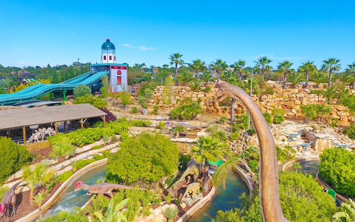 Aerial view of Zoomarine Algarve with dinosaur sculptures and water slides.
