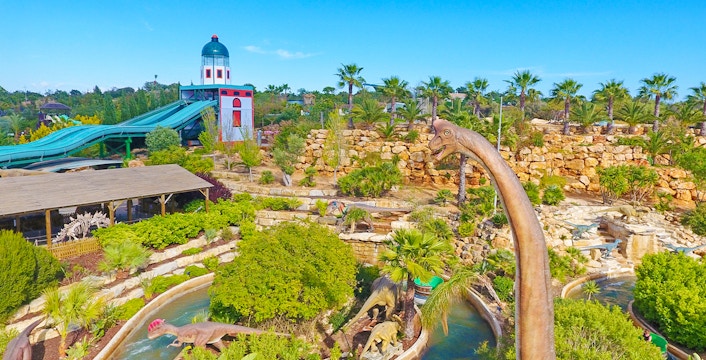 Aerial view of Zoomarine Algarve with dinosaur sculptures and water slides.