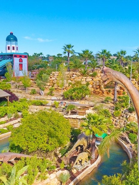 Aerial view of Zoomarine Algarve with dinosaur sculptures and water slides.