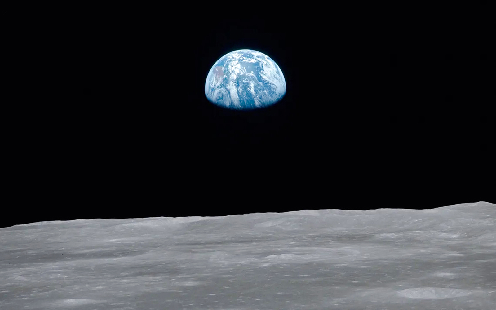 Earth rising over the lunar surface, featured in National History Museum's Story of the Earth exhibit.