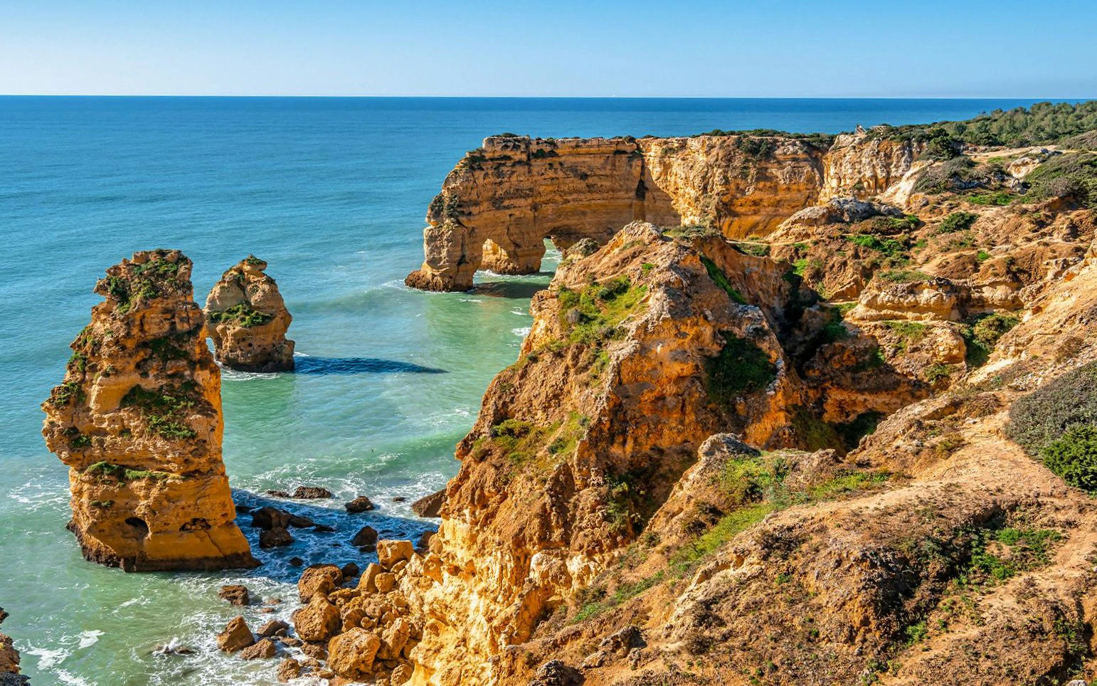 Praia da Marinha Beach with rock islets and cliffs from Seven Hanging Valleys Trail, Algarve, Portugal.