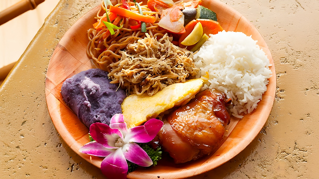 Imu-roasted dishes with rice, noodles, and purple sweet potato at Luau Kalamaku buffet.