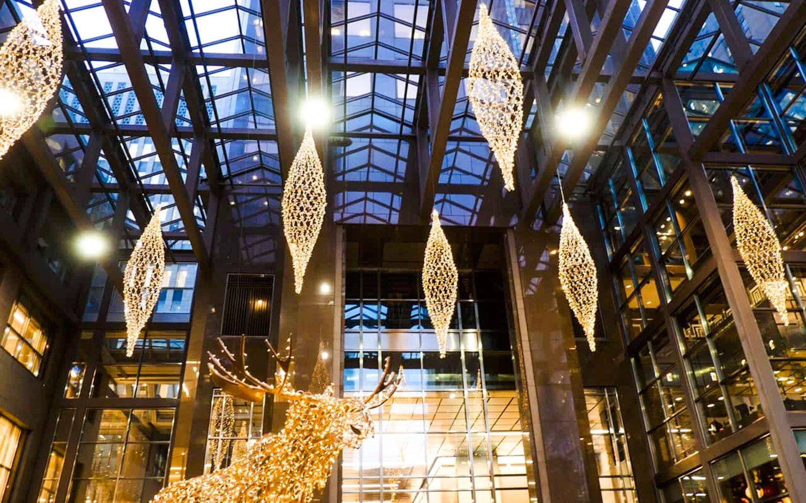 Atrium of Scotia Plaza in Toronto with hanging lights and glass ceiling.