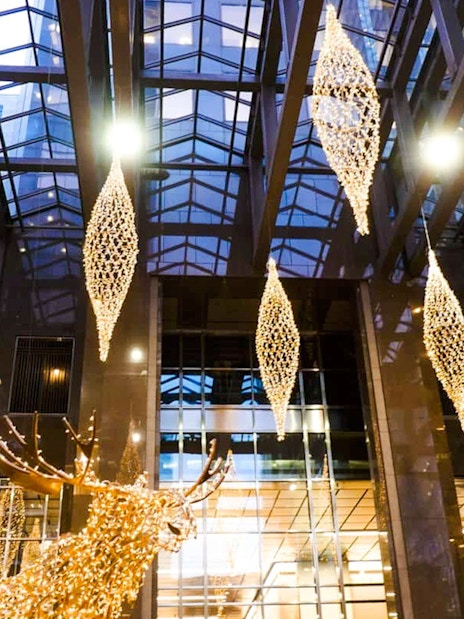 Atrium of Scotia Plaza in Toronto with hanging lights and glass ceiling.