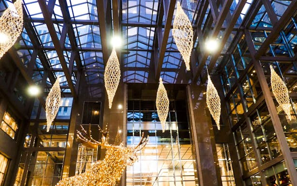 Atrium of Scotia Plaza in Toronto with hanging lights and glass ceiling.