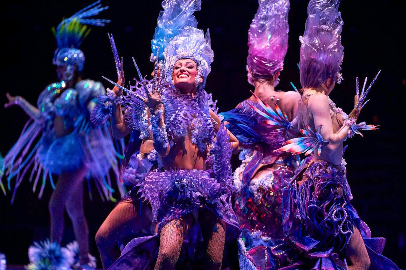 Performers in vibrant costumes during the Awakening show.