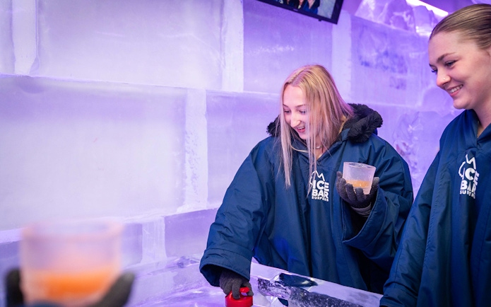 Guests enjoying drinks at IceBar Surfers Paradise, surrounded by ice walls.