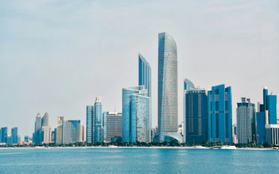 Abu Dhabi skyline with modern skyscrapers viewed from the water.