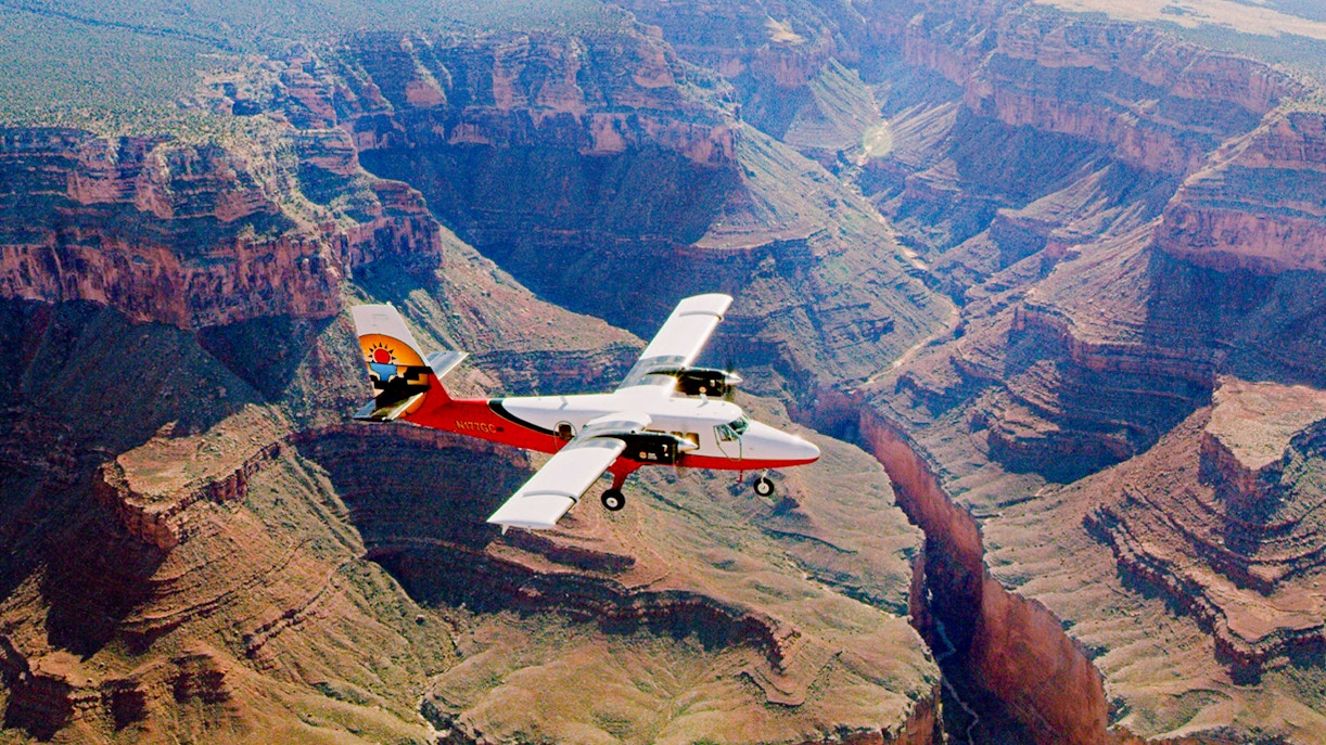 Aircraft flying over the Grand Canyon with a view of the canyon's vast landscape.