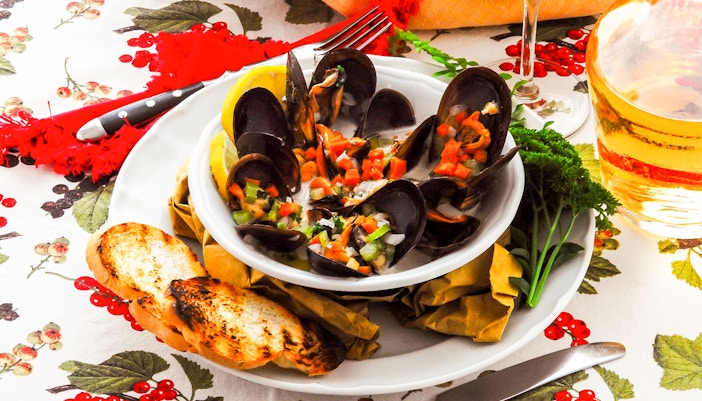 Zuppa di cozze served in a white bowl with fresh mussels and herbs in Italy.