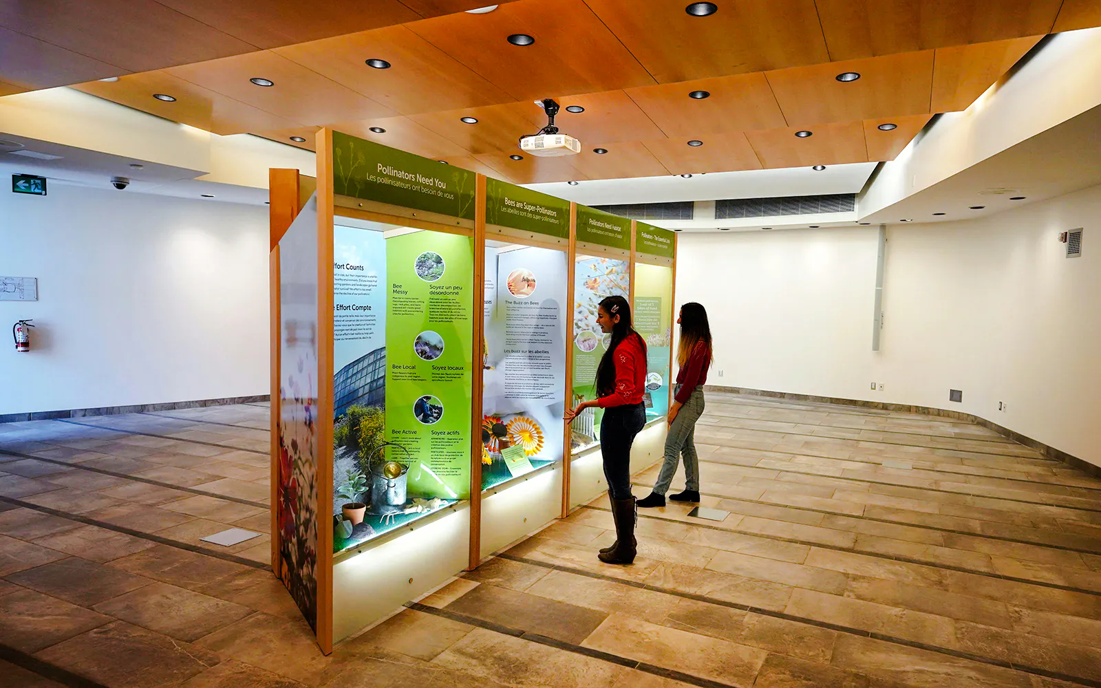 Visitors reading educational displays at the Butterfly Conservatory, Niagara Falls, Canada.