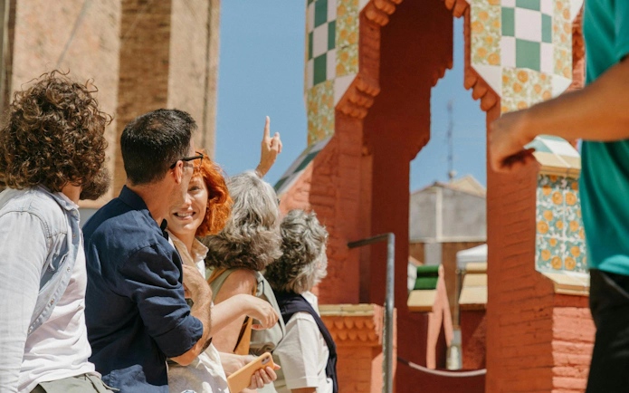 Tourists exploring Casa Vicens rooftop with colorful tiles in Barcelona.
