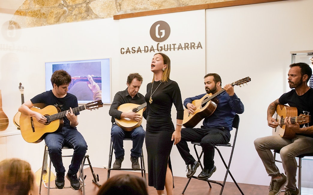 Musicians performing at a Fado show in Casa da Guitarra, Porto.