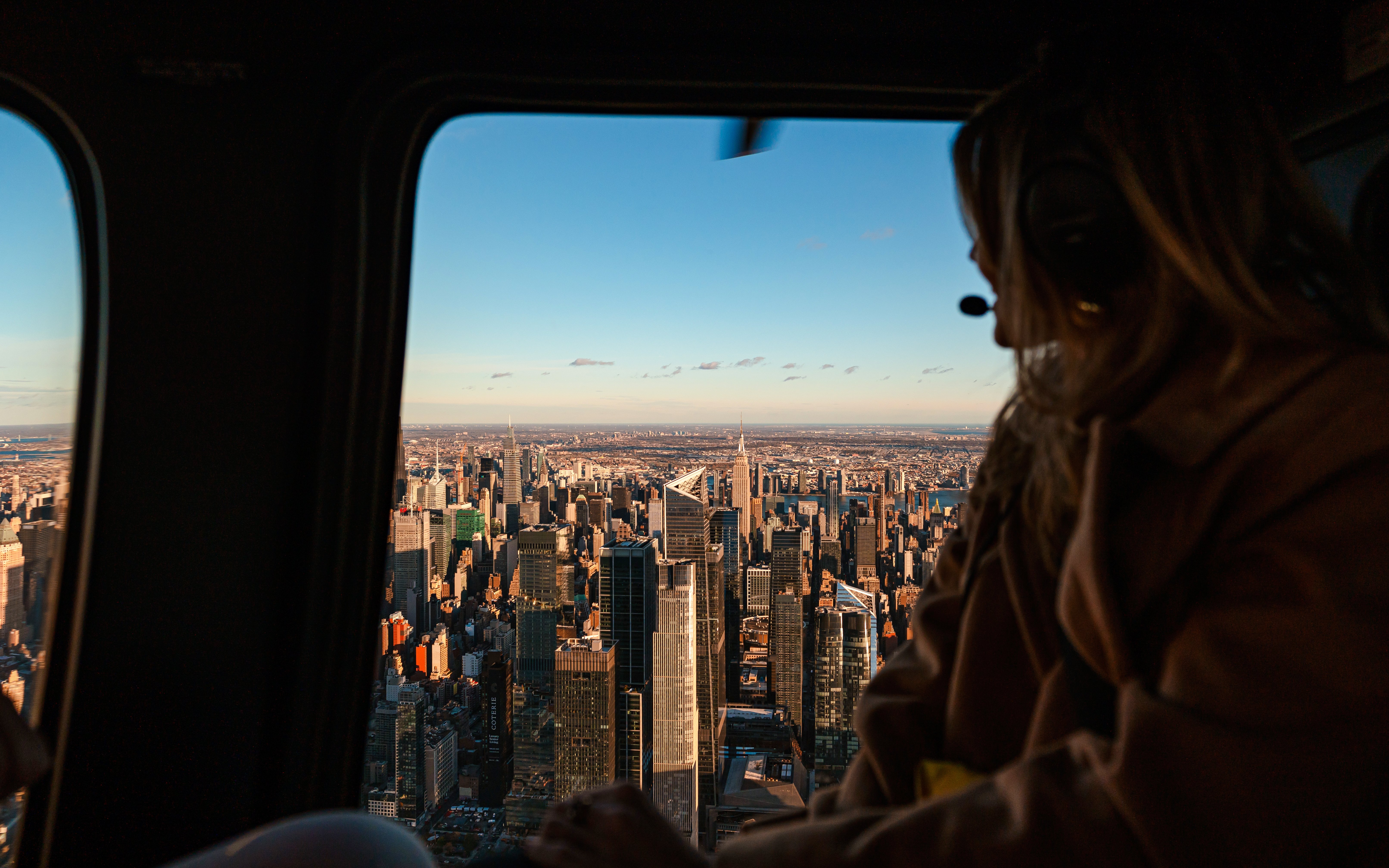 Helicopter view of New York City skyline with Empire State Building.