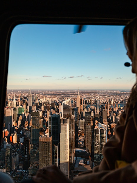Helicopter view of New York City skyline with Empire State Building.