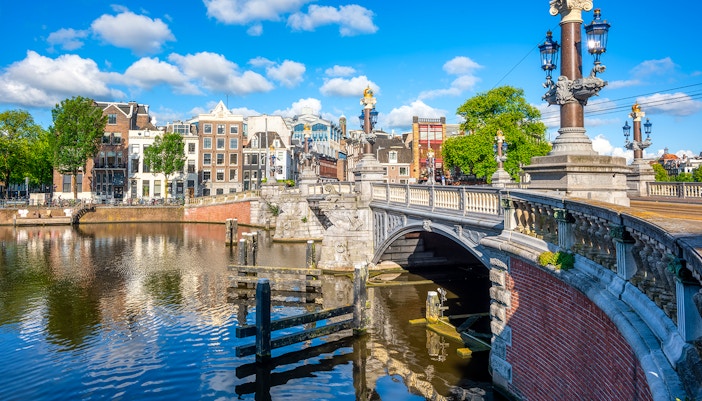 Blauwbrug bridge over Amstel River in Amsterdam with historic architecture.