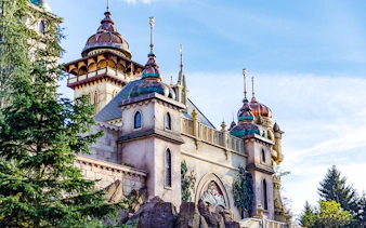 Efteling castle exterior with ornate towers and lush greenery in Amsterdam.
