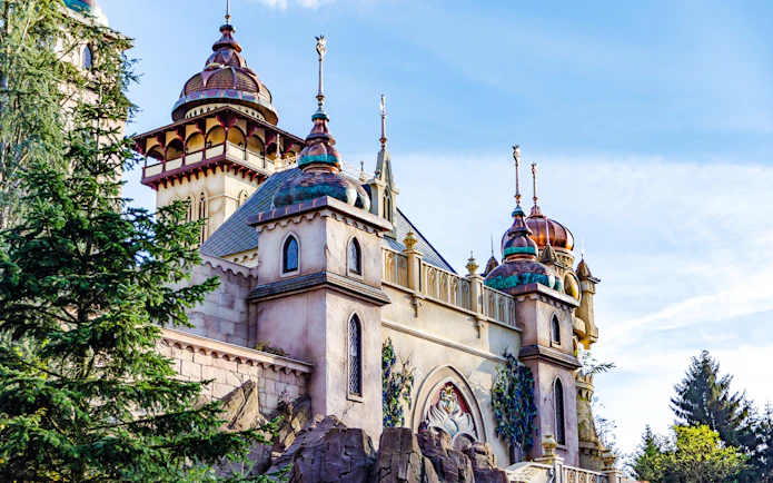 Efteling castle exterior with ornate towers and lush greenery in Amsterdam.