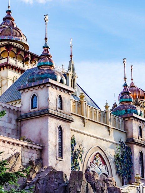 Efteling castle exterior with ornate towers and lush greenery in Amsterdam.
