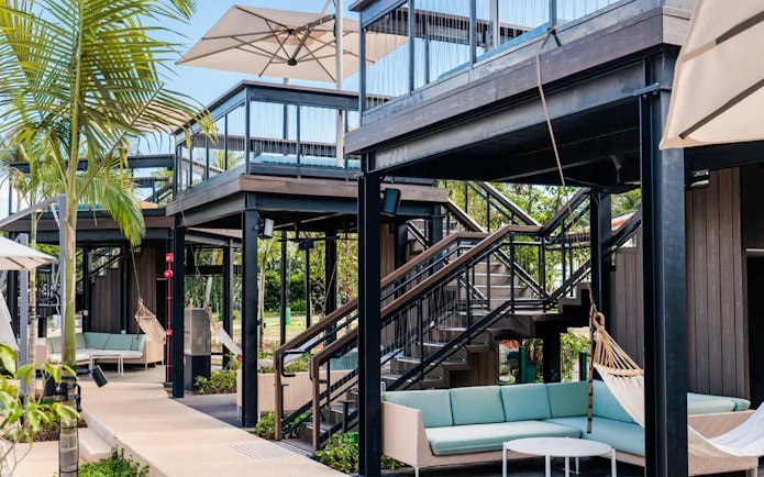 Splash Tribe Gazebo with outdoor seating and hammocks under a modern structure.