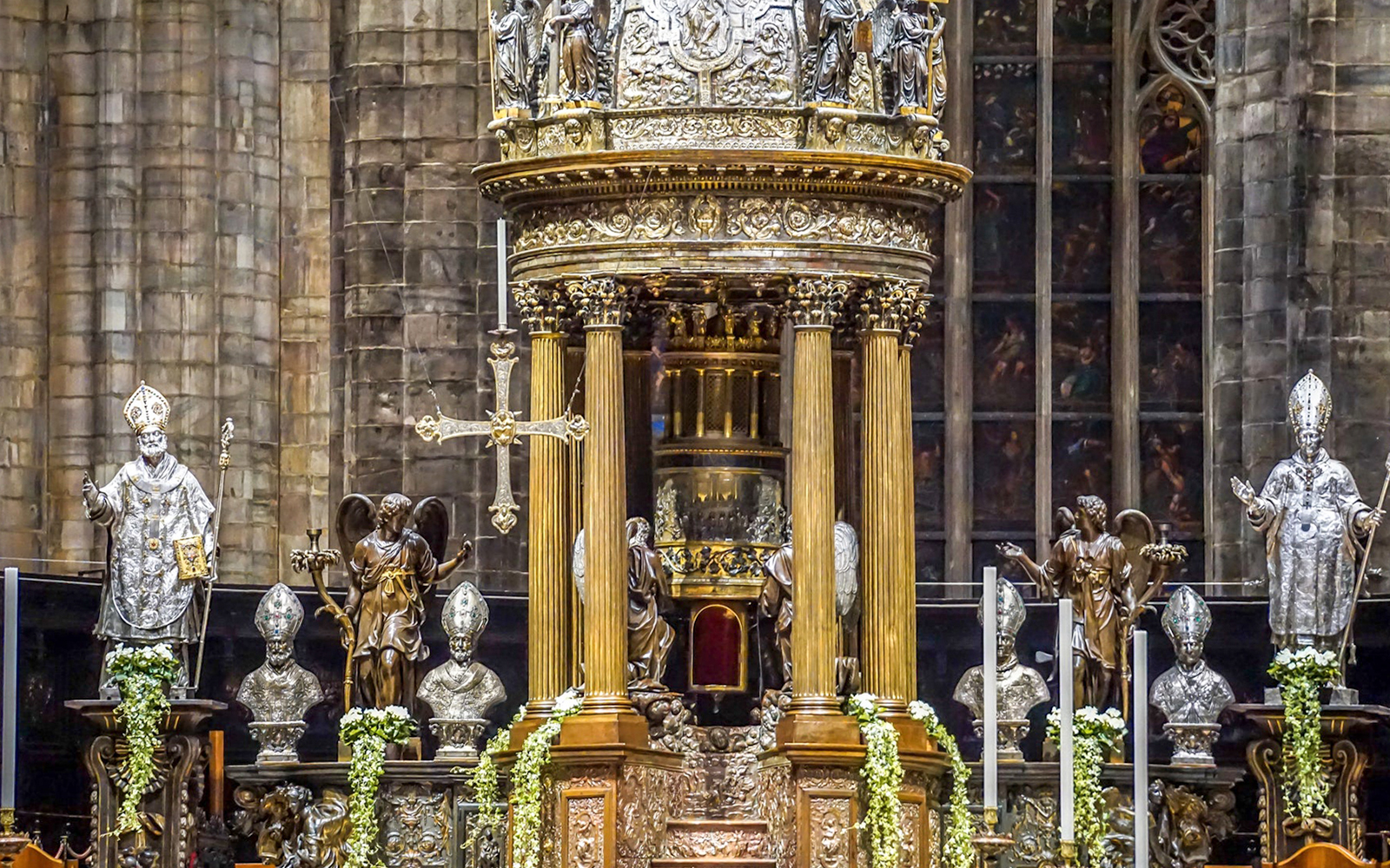 Duomo Milan Cathedral interior with ornate altar and religious statues.
