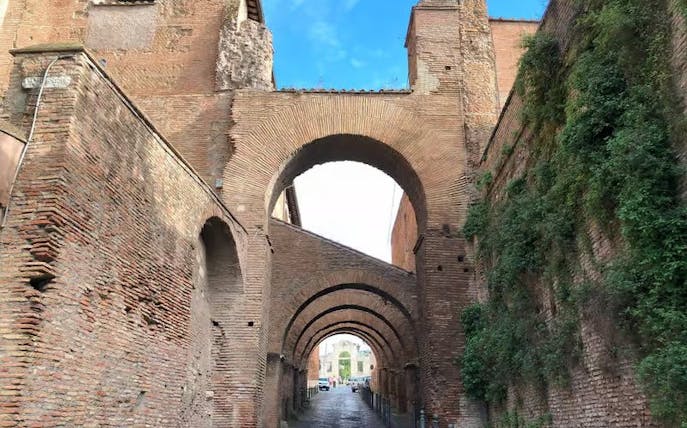 Roman brick arches on Celio Hill, Rome, leading to ancient underground houses.