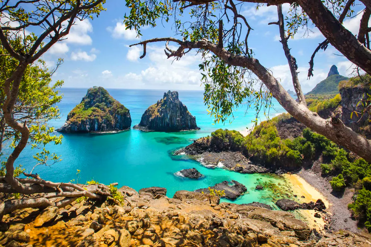 Noronha coast view with turquoise waters and rocky islets, seen from a cliff, Sao Paulo.