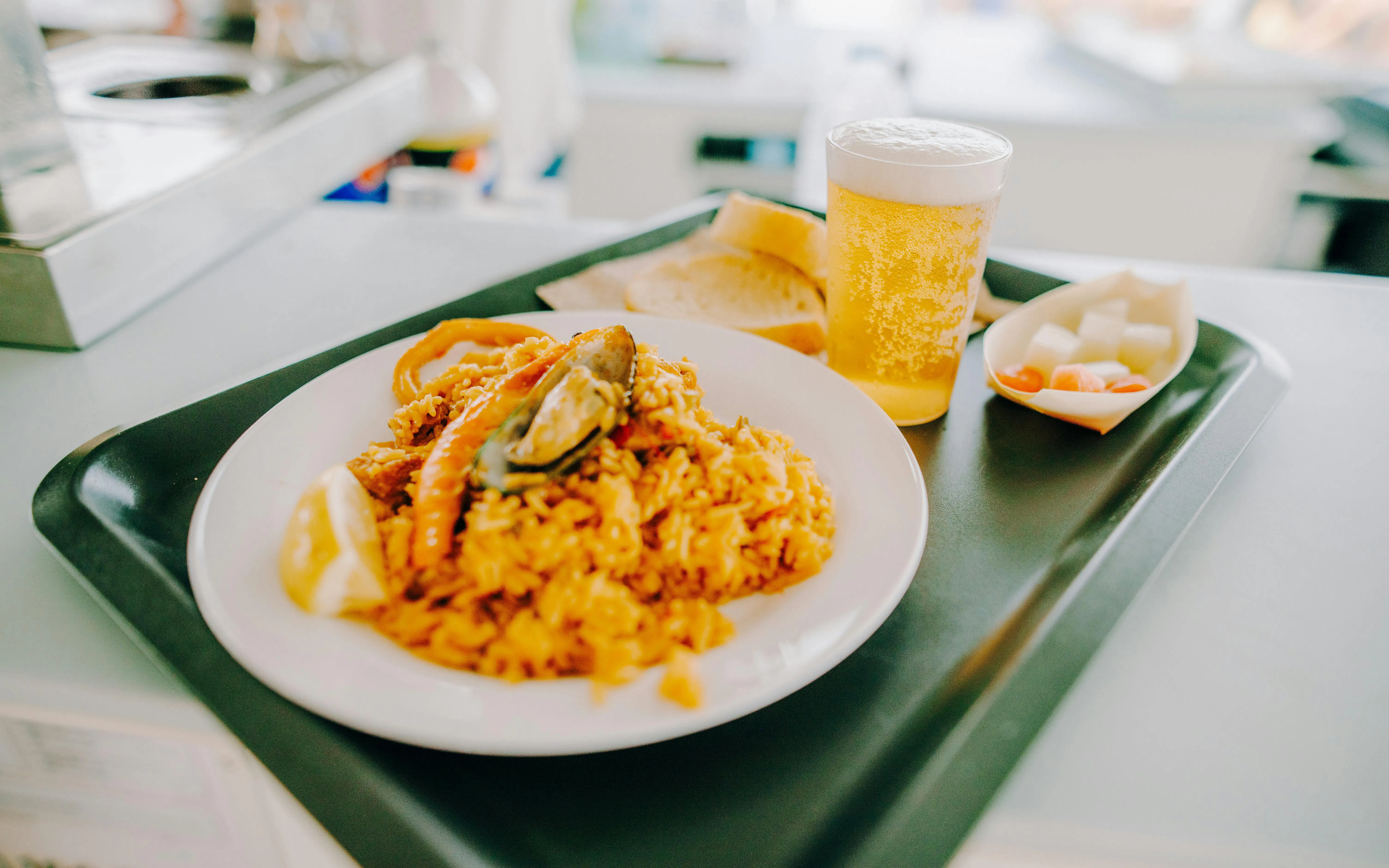 Seafood paella with bread and beer on La Graciosa Island cruise lunch.
