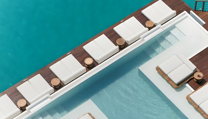 Tourists enjoying the Yona Beach Club Experience in Phuket, featuring a vibrant beach party with exclusive access to the club