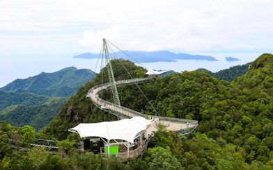 Sky Bridge at Langkawi spanning lush green mountains with distant sea view.
