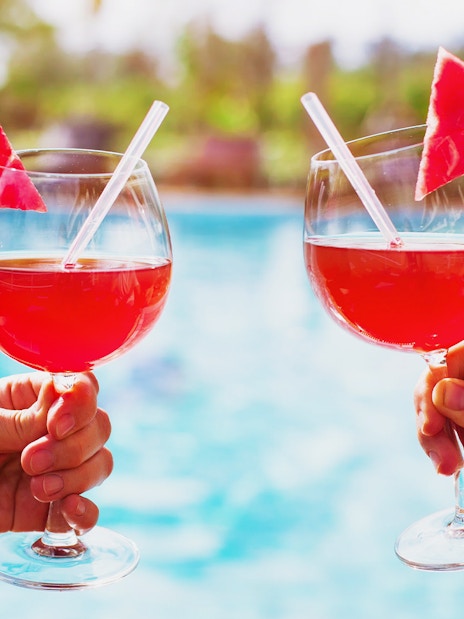 Tourists holding drinks by the thermal pool at Therme Bucuresti Spa, Bucharest.