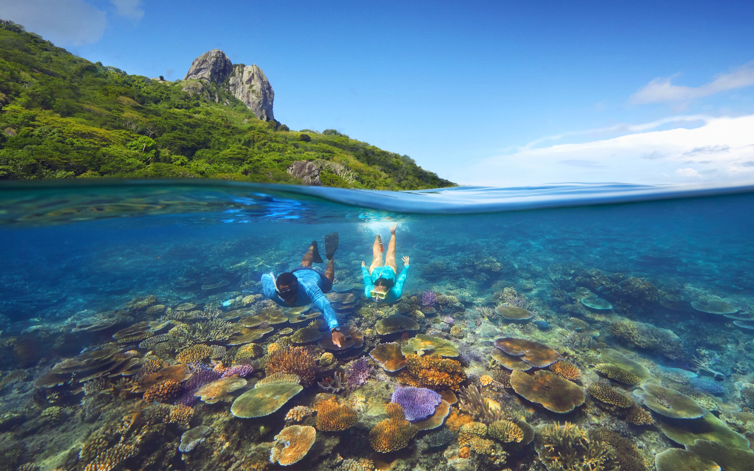 Snorkeling over coral reefs with marine biologist at Kuata Island, Fiji.