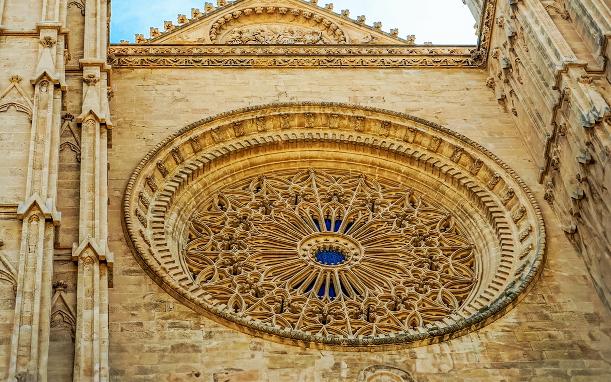 Rose window detail at Palma Cathedral, Mallorca, showcasing intricate Gothic architecture.